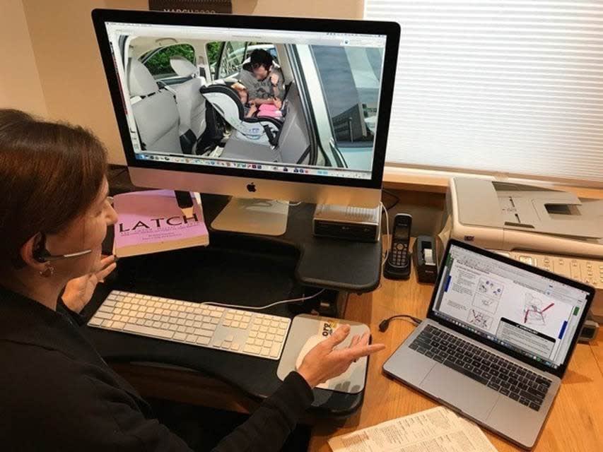 Woman helping to properly install a car seat virtually