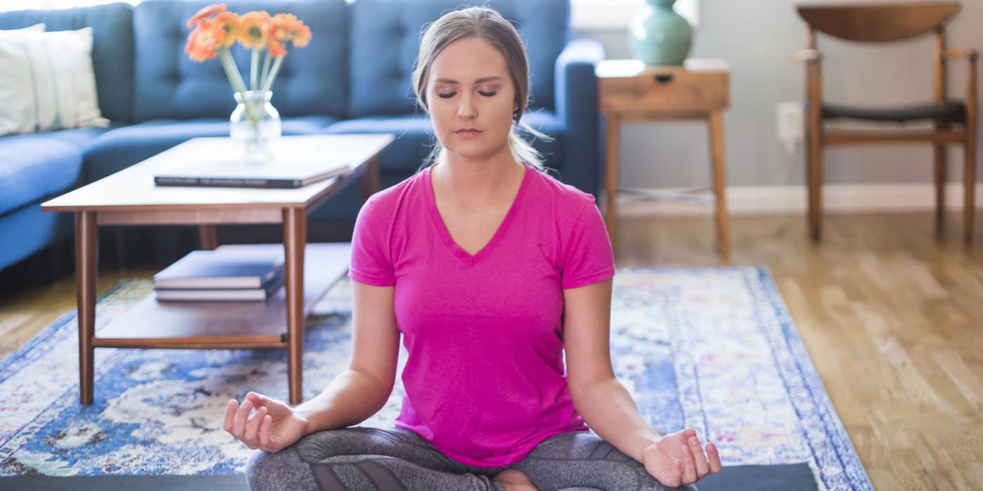 Woman doing yoga in living room