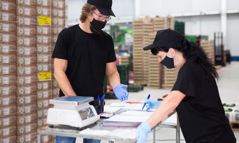 Two workers wearing masks and gloves