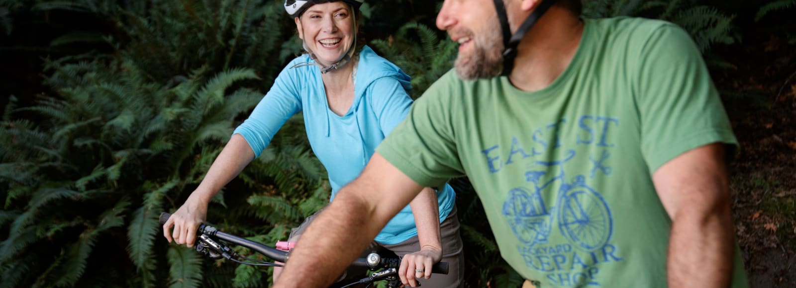 Couple smiling on bikes