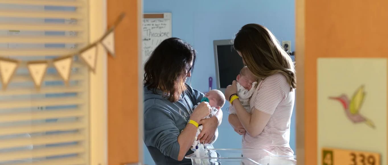 Two women holding babies.