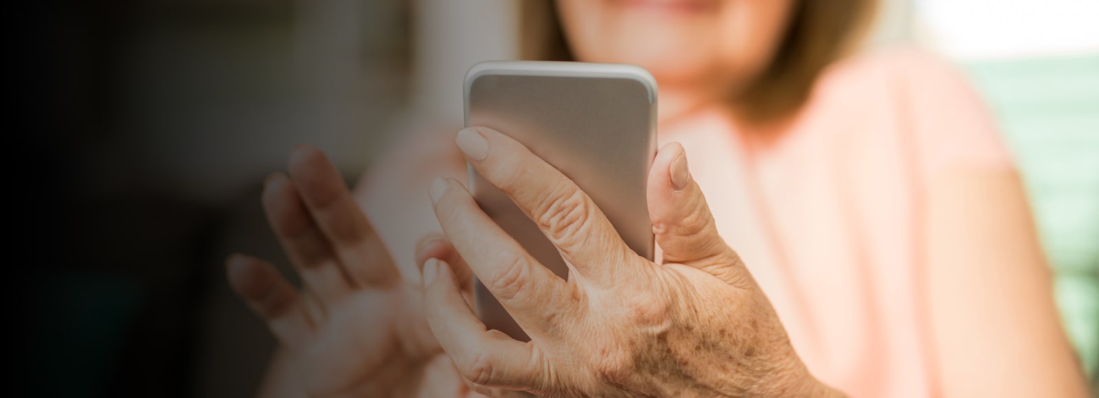 Woman holding phone in one hand