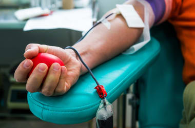 Hand grabbing a stress ball to give blood.