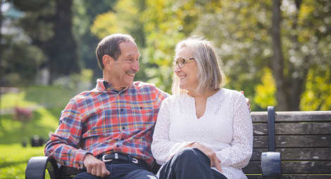 A man and woman sitting on a bench