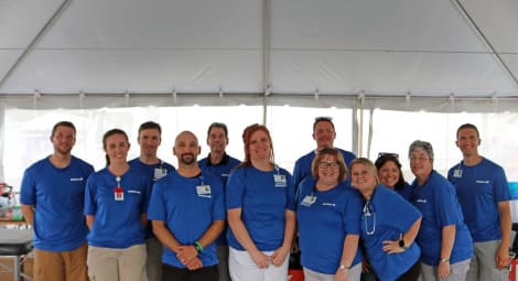 Employees under tent at event