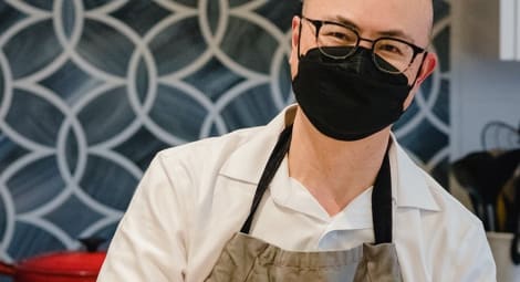 Dr. Myint cooking in his kitchen