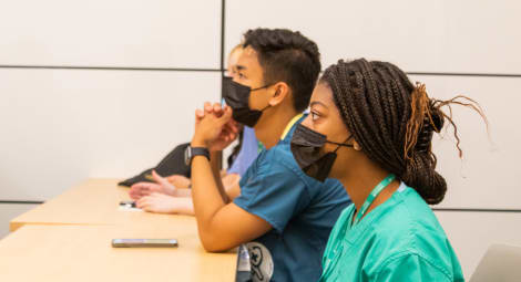 Students at a desk.