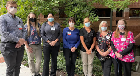 INW team posing for camera with face masks on