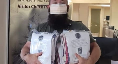 Man holds American flags in their packages.