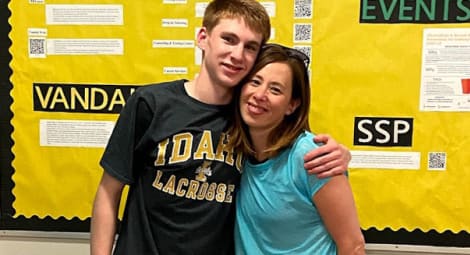 Young man and his mom hugging