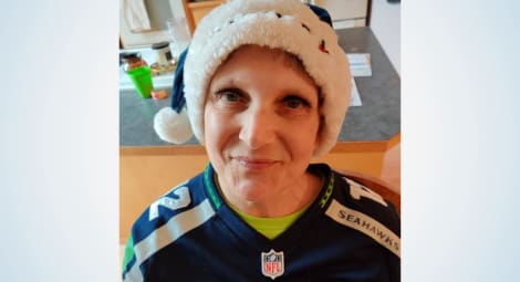 Woman wearing Seahawk gear.