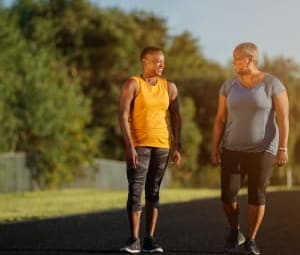 Two women walk on track