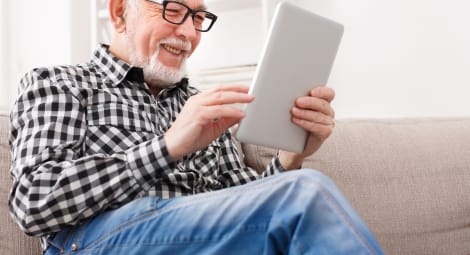 Senior man on digital tablet