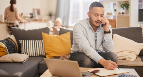 Male talking on the phone taking notes