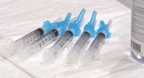 Five COVID vaccines in a line