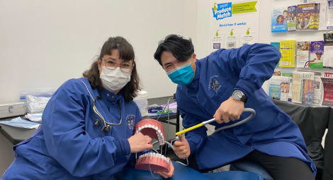 Two people at a dental clinic posing.