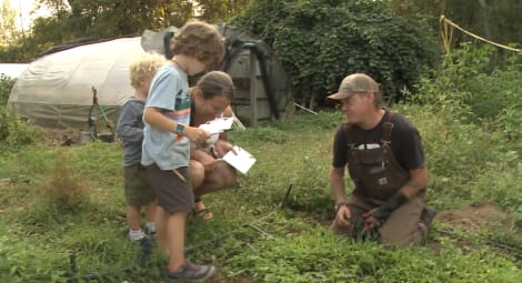 Kids learning in a garden.