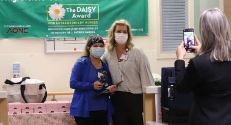 DAISY Award winner Melanie Ives, RN, and nurse manager Sarah Post, RN, pose for photos