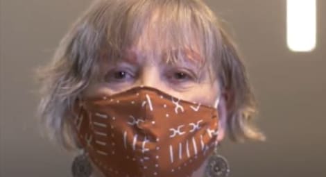 Woman with a mask on looking at the camera