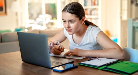 Teen girl studying on the computer