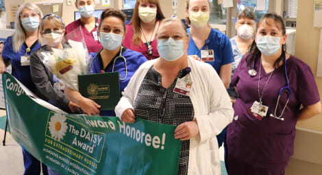 Nurses gathering with a banner