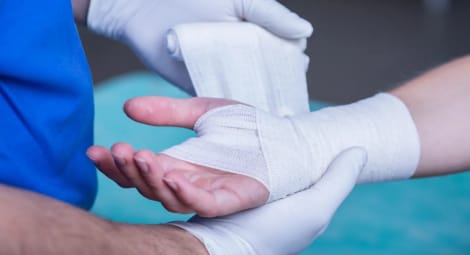 Medical provider wrapping an injured wrist