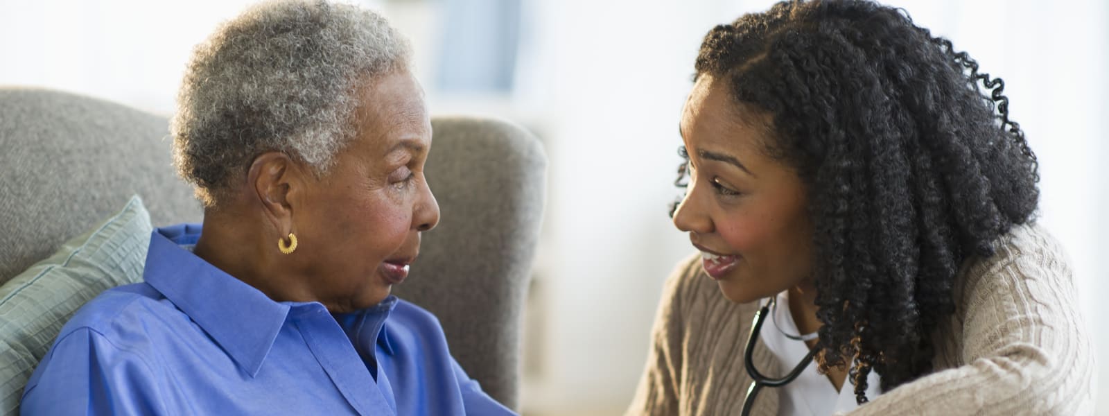 Nurse taking woman's blood pressure