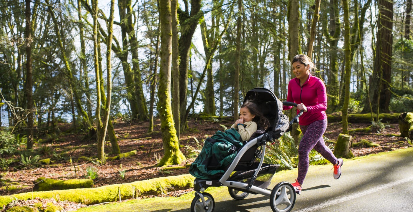 Mother jogging with a child in the stroller