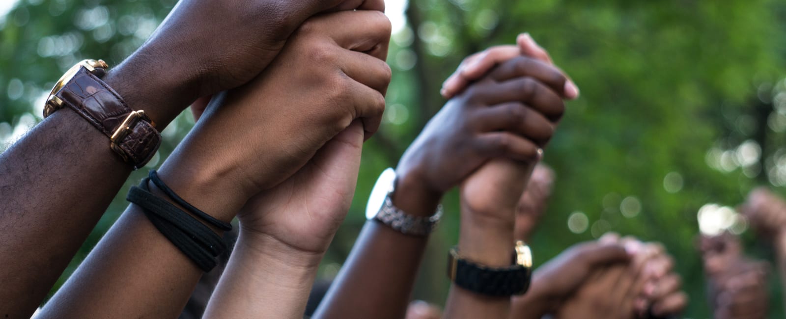 Hands raised in the hair holding other hands