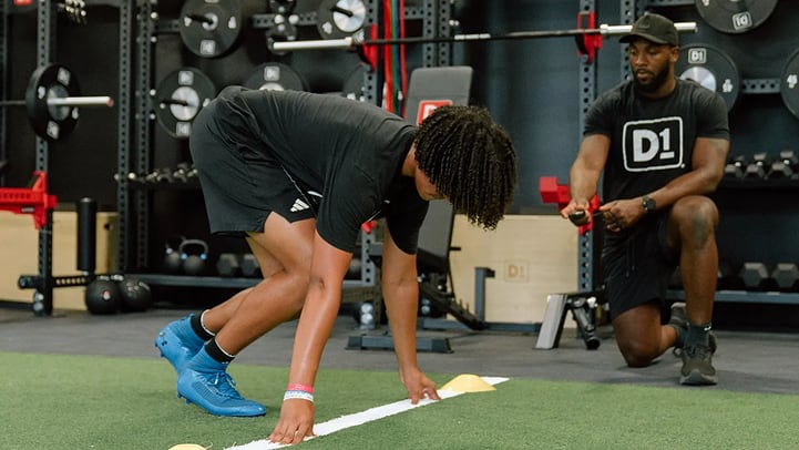 D1 Coach working with athlete