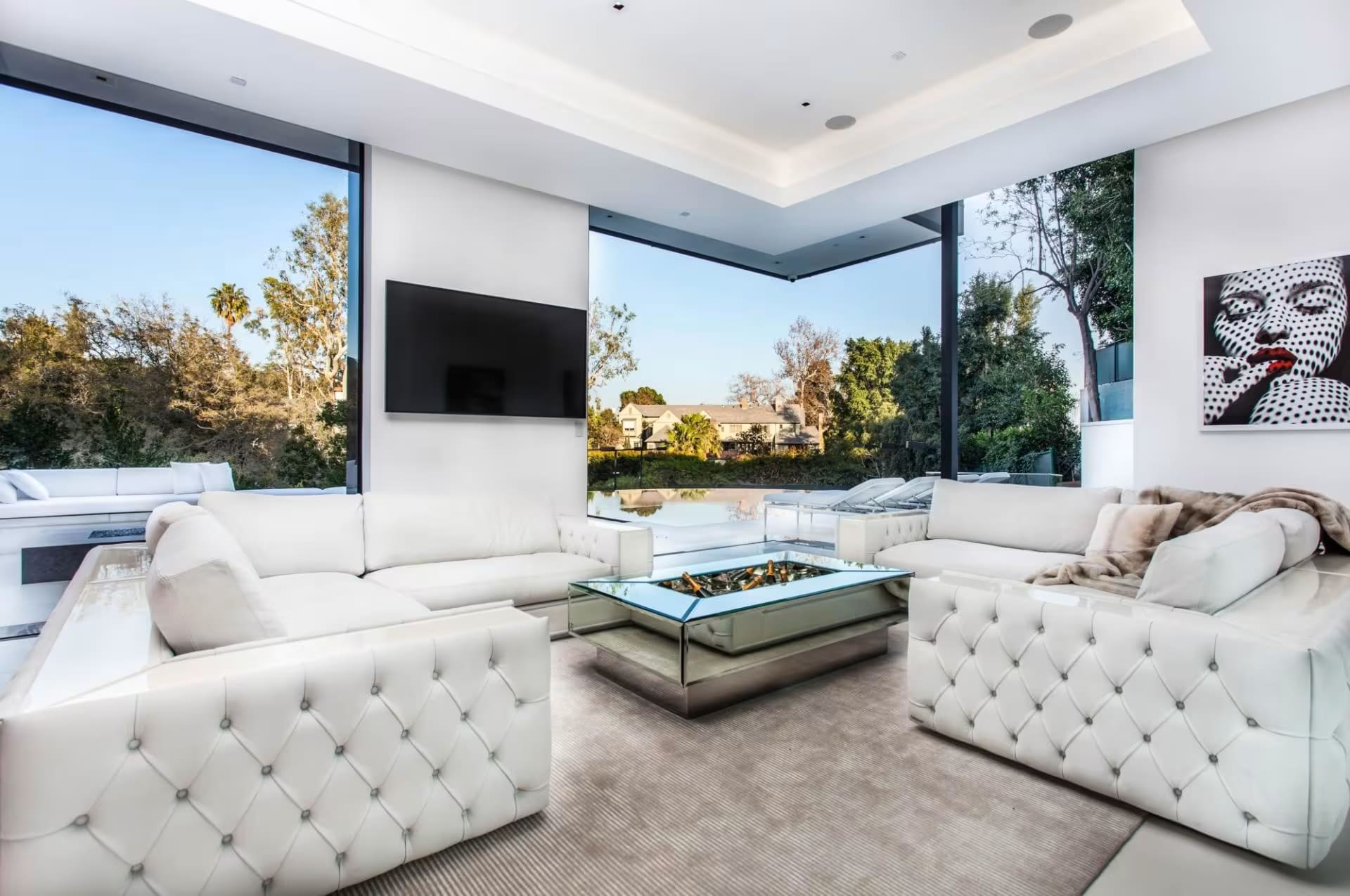 Custom White Leather Sofas & Modern Coffee Table – NYC Interior Design Bright and modern living space featuring handcrafted white leather sofas and glass coffee table, inspired by Design Within Reach.