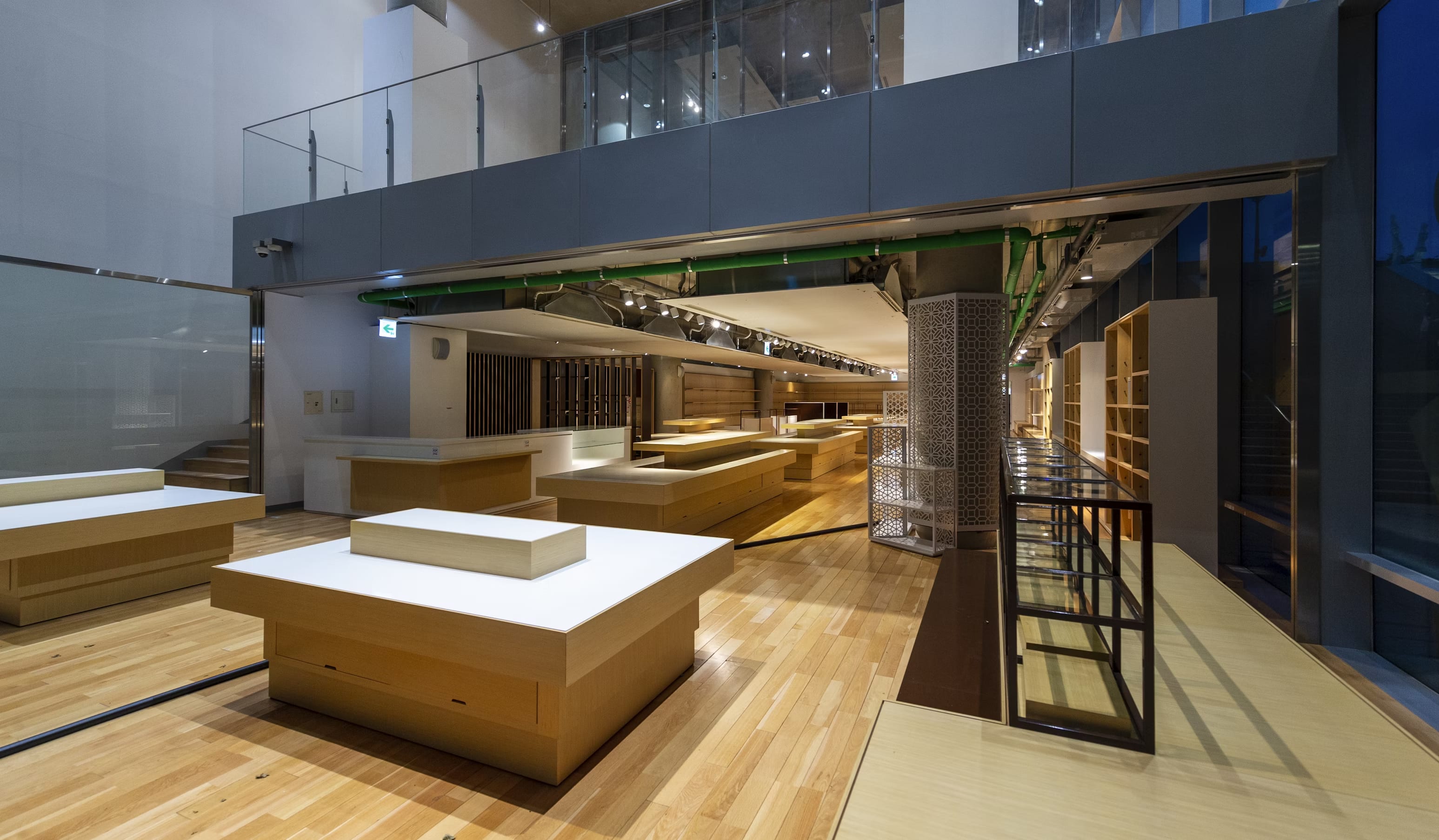 High-end furniture showroom expansion with modern wooden installations and architectural lighting.