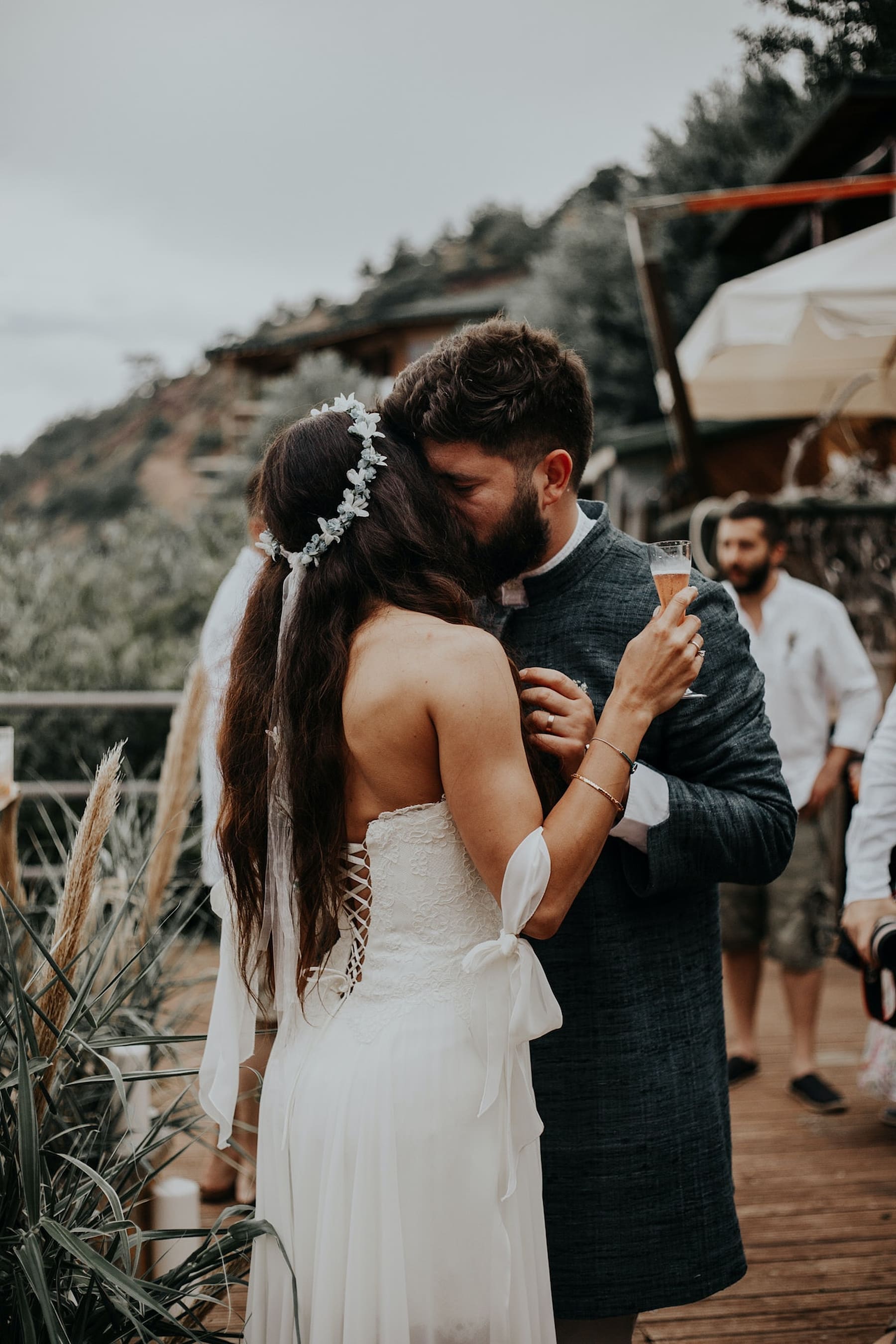 Bride and Groom embrace with champagne glasses