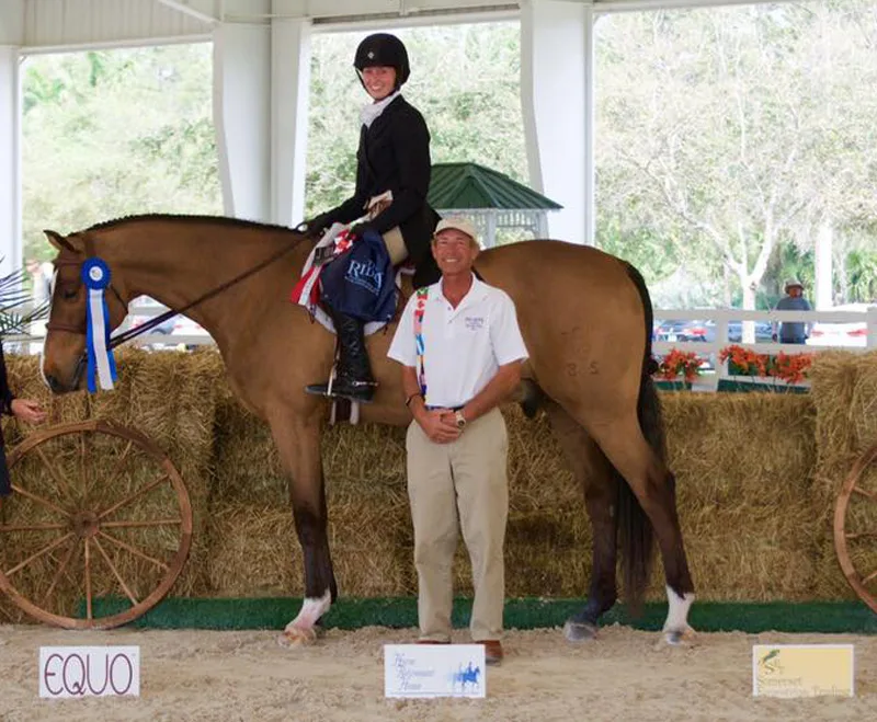 George d'Ambrosio of The Ridge Palm Bach Series (right) congratulated Hallie Buttenwieser and Wanderlust on their win in the $5,000 USHJA National Hunter Derby. Photo by Equinium Sports Marketing