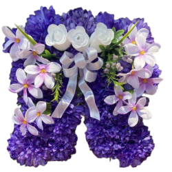 Silk flower arrangement shaped like angel wings made with purple and white flowers