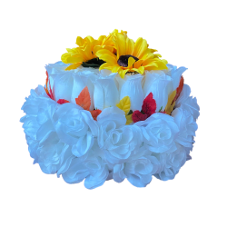 Silk flower arrangement shaped like a cake made with white and yellow flowers