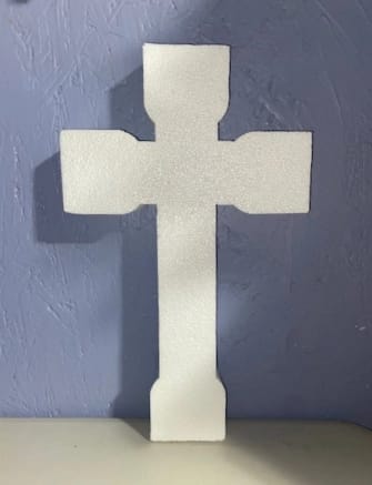 a polystyrene cutout shaped like a cross