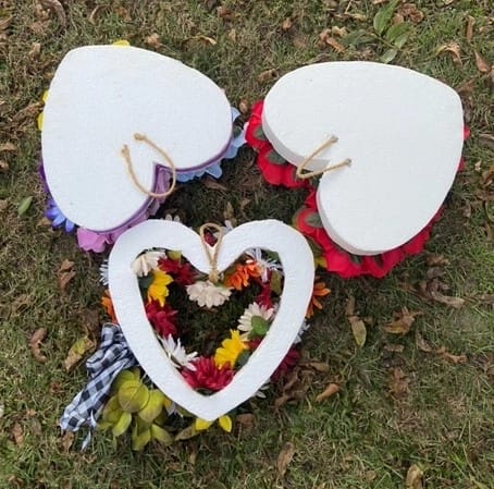 the backside of three polystyrene silk flower arrangements that shows how they look with grapevine wire
