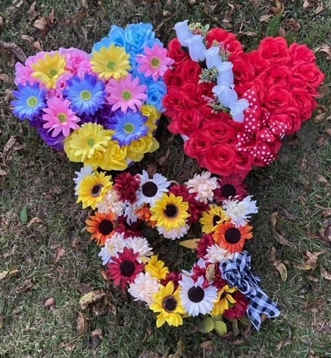 3 silk flower heart arrangements on the ground