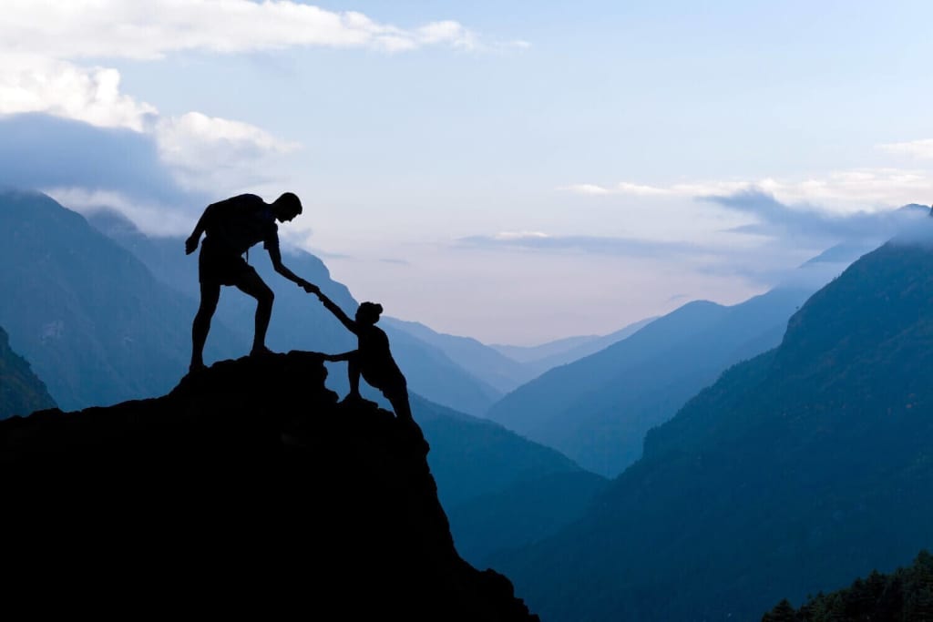 Teamwork helping each other.