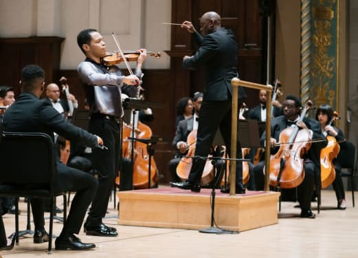 A vibrant concert stage with captivating visuals at the AOT Concert 2025