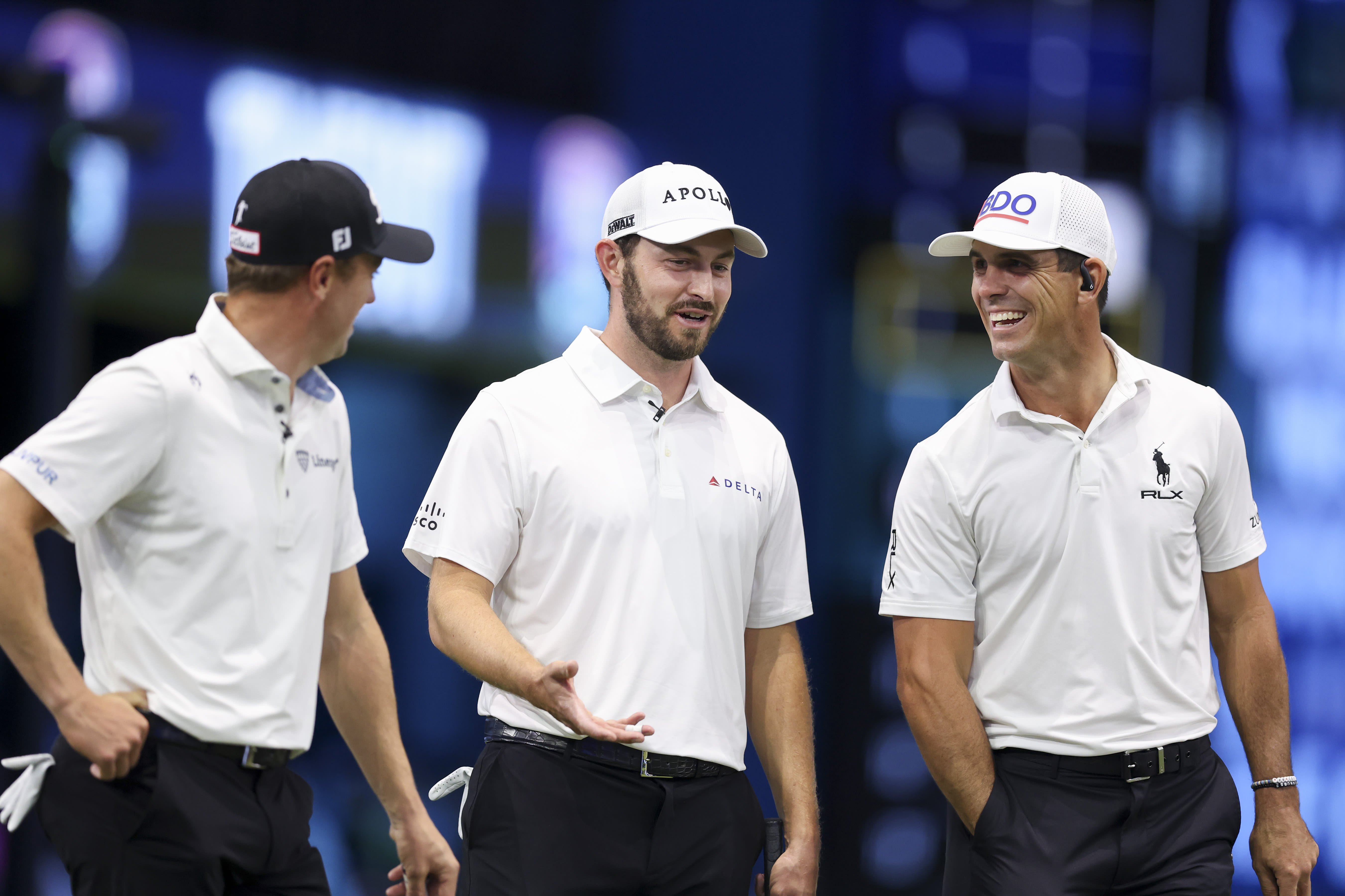 PALM BEACH GARDENS, FLORIDA - JANUARY 21: Patrick Cantlay of Atlanta Drive GC, middle, talks with teammates Billy Horschel, right, and Justin Thomas, left, during their TGL presented by SoFi match at SoFi Center on January 21, 2025 in Palm Beach Gardens, Florida. (Photo by Megan Briggs/TGL/TGL via Getty Images)