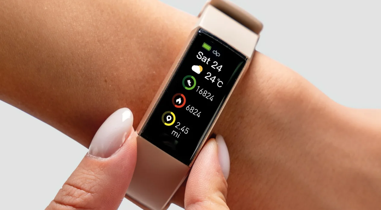 A smartwatch displays fitness metrics like steps and heart rate on the screen. A person is adjusting it on their wrist in a neutral, gray-background setting.