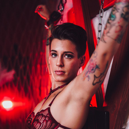 Red harness boudoir portrait — neon red lighting