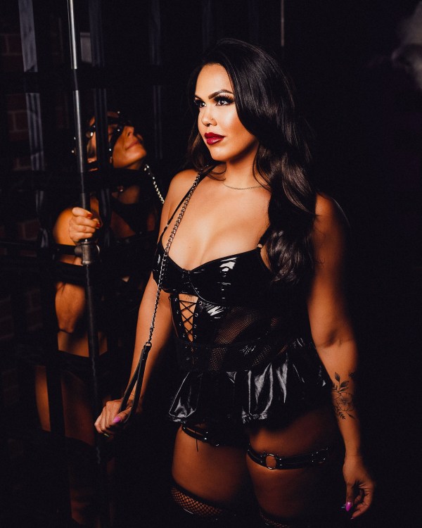 Black vinyl corset portrait — dark moody boudoir