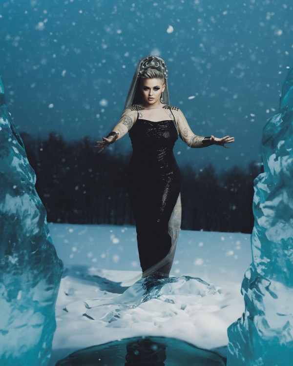 Ice queen in snow with crystal ice columns — dark fantasy portrait