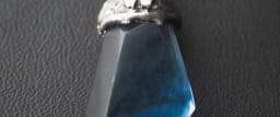 A cabochon moonstone with blue adularescence across its dome