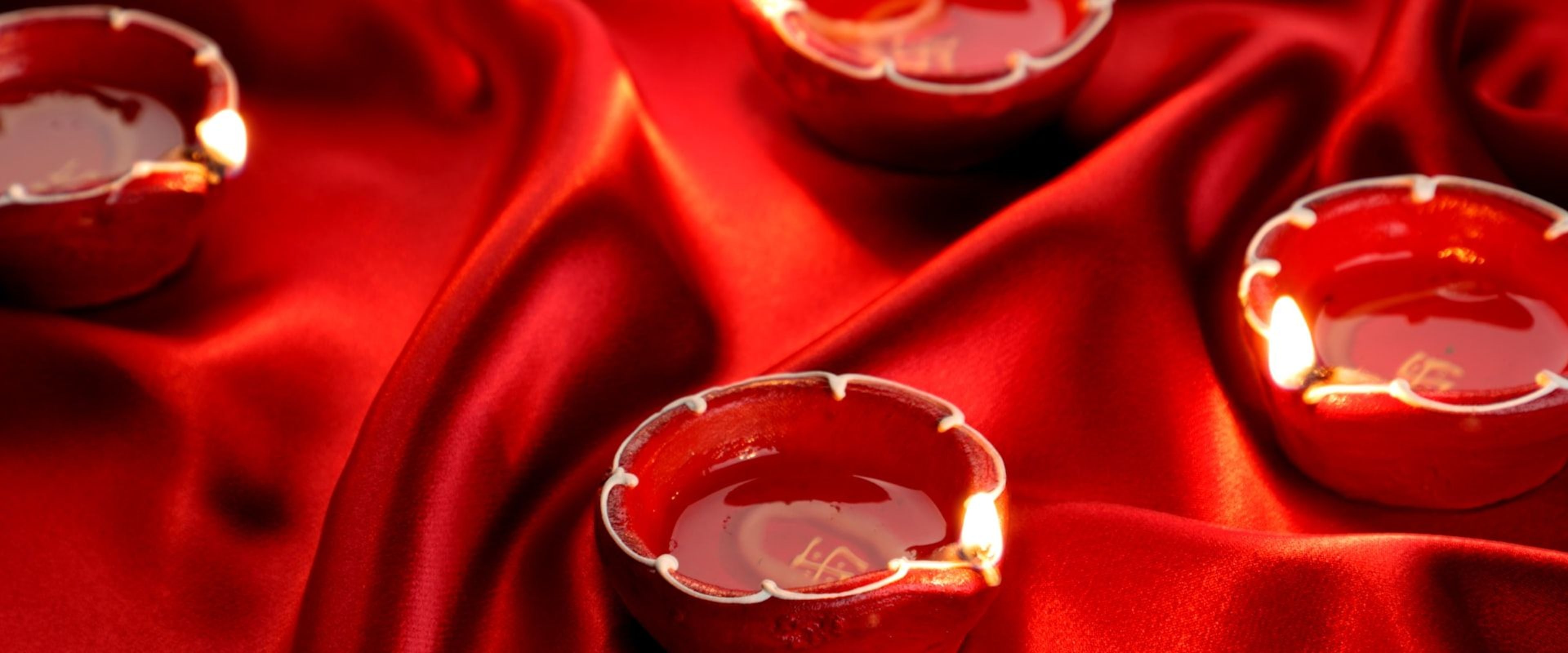 An oval ruby with strong red saturation on a grey background