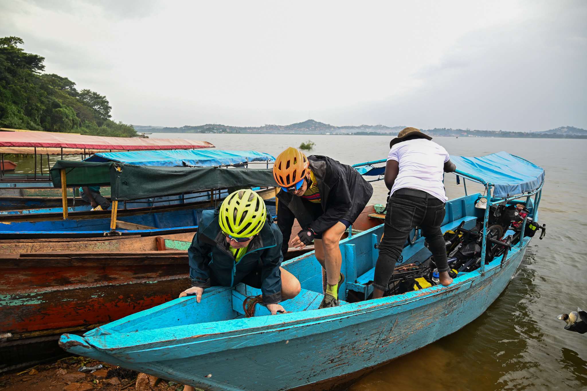 Ulee and Eva hop off the boat after a short ride from Entebbe