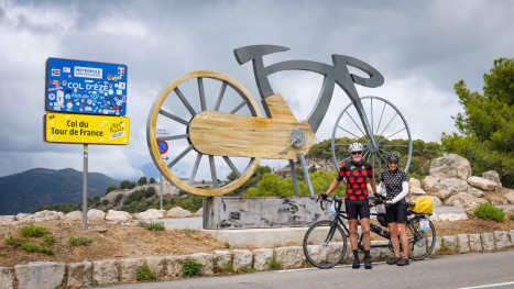 The Trans-Europa Cycling Tour: A 'Crazy European Diagonal' Mike and Marg pose in front of a Tour de France section in France